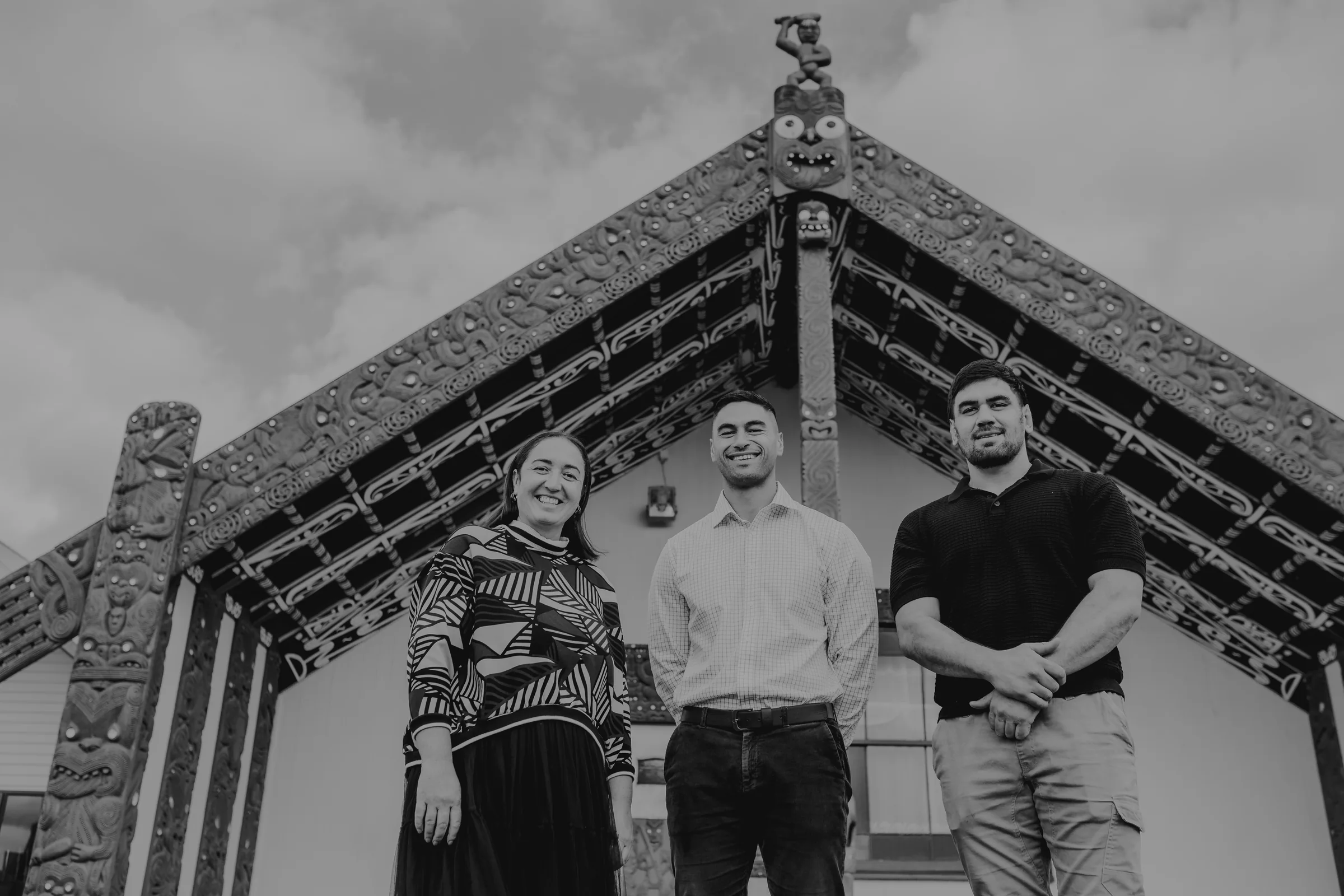 The Whānau Builds team standing in front of a wharenui